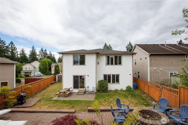 1344 Foreman Rd, Dupont, WA 98327 - rear view of house with a fire pit, entry steps, a patio area, and a fenced backyard