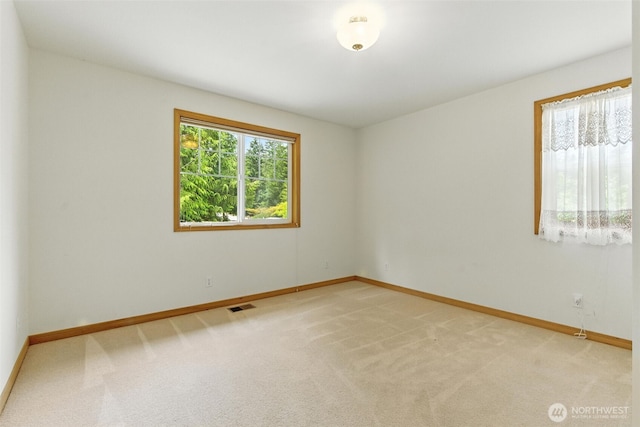 442 Rhododendron Dr, Sequim, WA 98382 - spare room featuring baseboards and light carpet