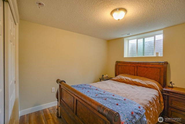 19910 NE 356th St, Yacolt, WA 98675 - bedroom with dark wood-style floors and a textured ceiling
