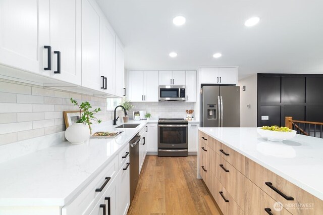 2316 67th Ave NE, Tacoma, WA 98422 - kitchen featuring stainless steel appliances, light wood finished floors, decorative backsplash, recessed lighting, and white cabinets