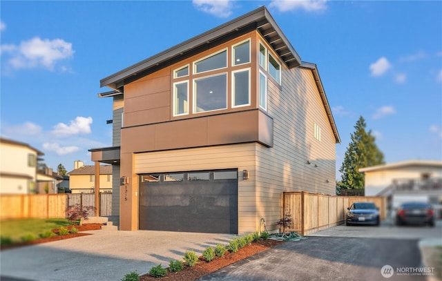1225 S 234th Dr, Des Moines, WA 98198 - contemporary home with asphalt driveway and an attached garage