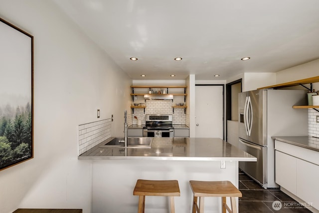 1000 Union St Unit 215, Seattle, WA 98101 - kitchen featuring appliances with stainless steel finishes, open shelves, decorative backsplash, white cabinets, and under cabinet range hood