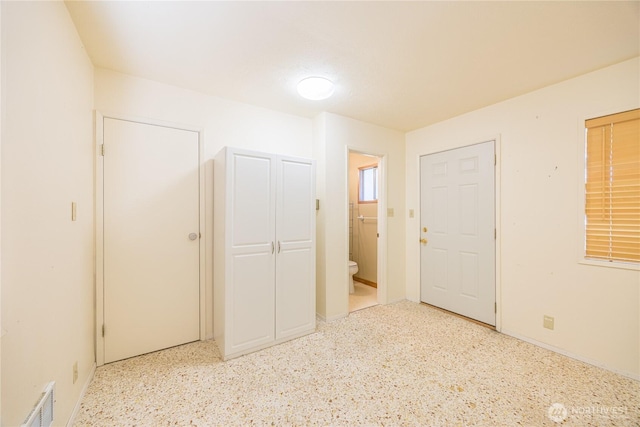 702 E Alder, Sequim, WA 98382 - unfurnished bedroom featuring ensuite bath and dark speckled floor