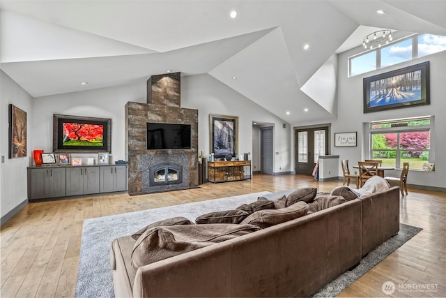 140 Bowers, Chehalis, WA 98532 - living area with hardwood / wood-style flooring, plenty of natural light, high vaulted ceiling, a tiled fireplace, and recessed lighting