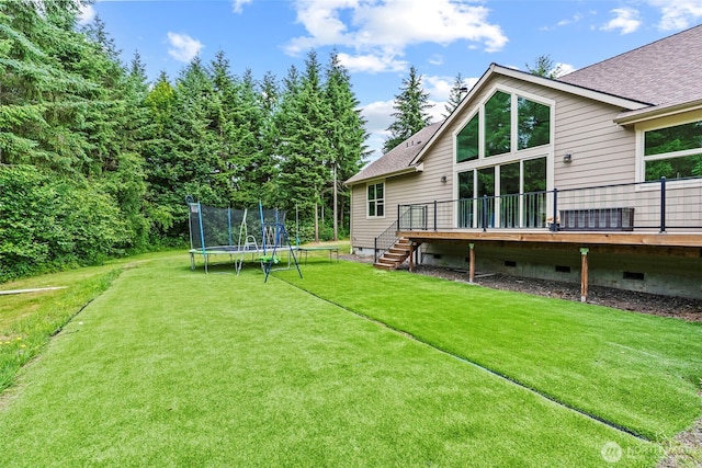 140 Bowers, Chehalis, WA 98532 - view of grassy yard featuring a trampoline, a deck, and stairs