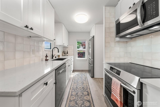 102 NW 132nd St, Seattle, WA 98177 - kitchen featuring appliances with stainless steel finishes, tasteful backsplash, and white cabinetry