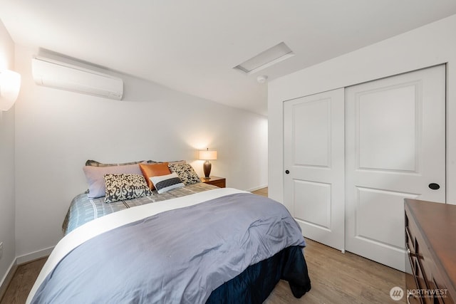 102 NW 132nd St, Seattle, WA 98177 - bedroom with attic access, a wall mounted air conditioner, light wood finished floors, and a closet