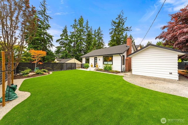 102 NW 132nd St, Seattle, WA 98177 - back of house featuring a fenced backyard, a chimney, a shingled roof, and an outbuilding