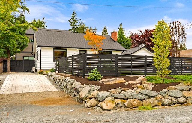 102 NW 132nd St, Seattle, WA 98177 - view of front of home featuring a shingled roof and a chimney