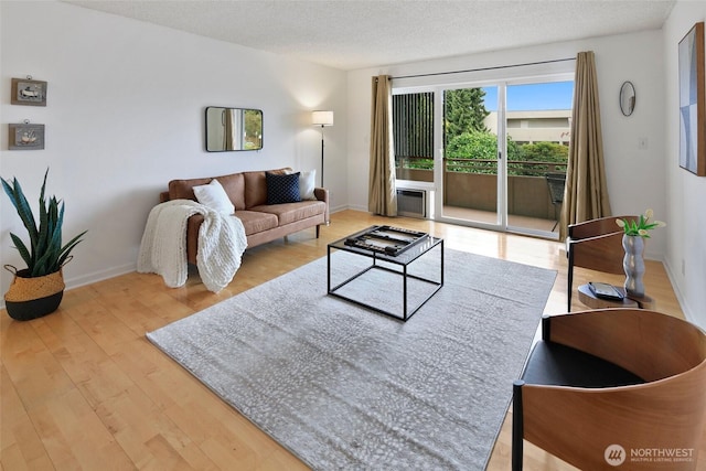4444 44th Ave SW Unit 101, Seattle, WA 98116 - living room with wood finished floors and a textured ceiling