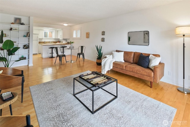 4444 44th Ave SW Unit 101, Seattle, WA 98116 - living room featuring light wood finished floors and baseboards