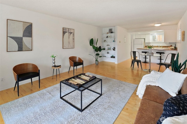 4444 44th Ave SW Unit 101, Seattle, WA 98116 - living area featuring light wood-style flooring and built in features