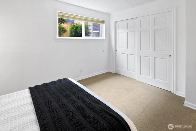 4444 44th Ave SW Unit 101, Seattle, WA 98116 - unfurnished bedroom featuring carpet, a closet, and a textured ceiling