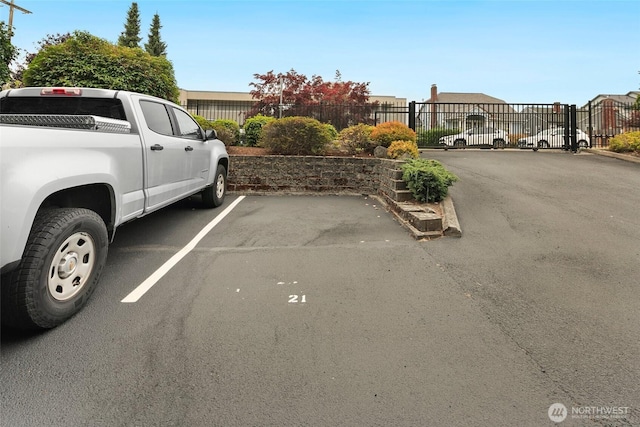 4444 44th Ave SW Unit 101, Seattle, WA 98116 - uncovered parking lot with a gate