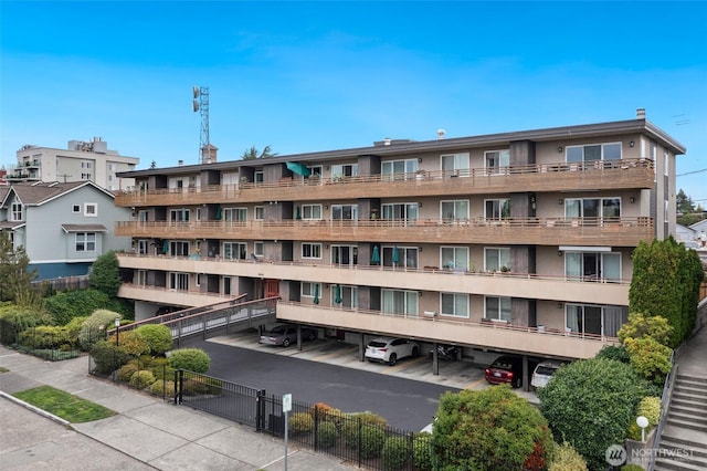 4444 44th Ave SW Unit 101, Seattle, WA 98116 - view of apartment building / complex featuring covered parking
