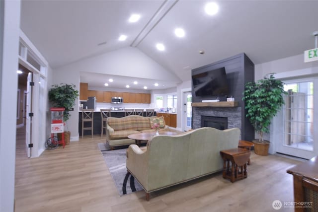 151540 140th Way SE Unit T101, Renton, WA 98058 - living room featuring a stone fireplace, light wood-type flooring, high vaulted ceiling, and recessed lighting