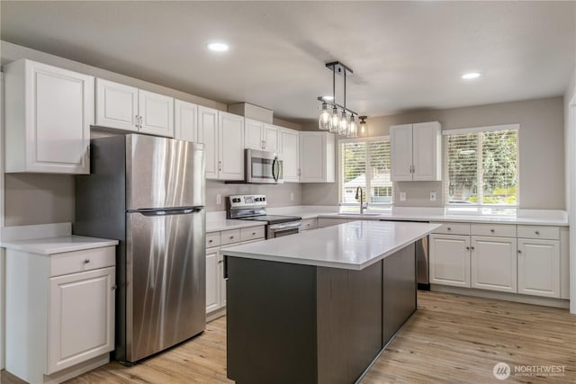 1513 154th St E, Tacoma, WA 98445 - kitchen with appliances with stainless steel finishes, white cabinetry, light countertops, and recessed lighting