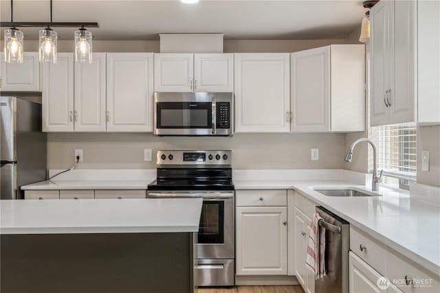 1513 154th St E, Tacoma, WA 98445 - kitchen featuring appliances with stainless steel finishes, white cabinetry, and light countertops