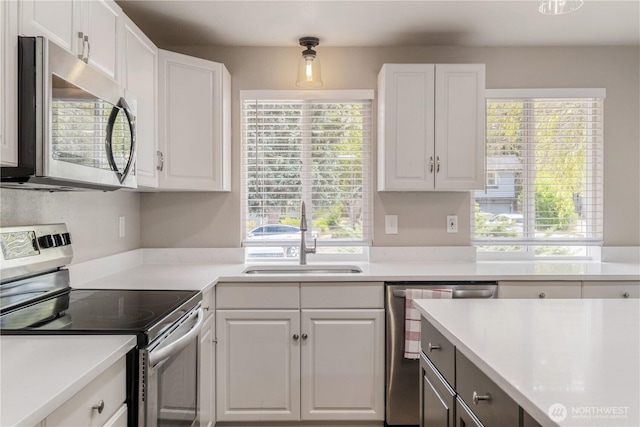 1513 154th St E, Tacoma, WA 98445 - kitchen with appliances with stainless steel finishes, white cabinets, and light countertops