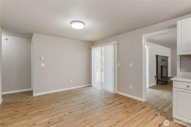 1513 154th St E, Tacoma, WA 98445 - unfurnished room featuring a fireplace and light wood finished floors