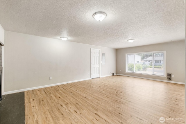 1513 154th St E, Tacoma, WA 98445 - empty room featuring a textured ceiling, wood finished floors, and electric panel