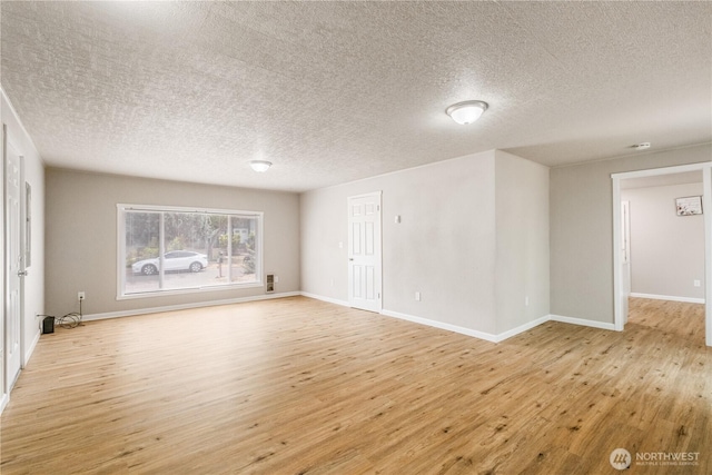 1513 154th St E, Tacoma, WA 98445 - empty room featuring light wood-style flooring and a textured ceiling