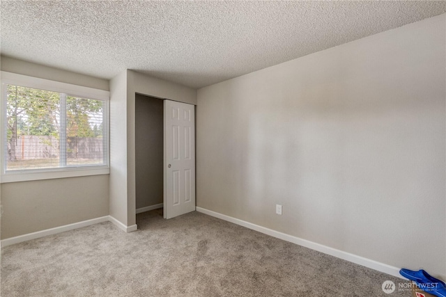 1513 154th St E, Tacoma, WA 98445 - unfurnished bedroom with carpet, a textured ceiling, and a closet