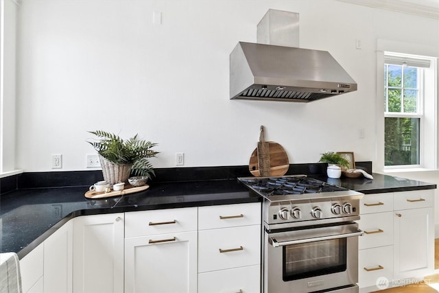 1615 Monroe St, Bellingham, WA 98225 - kitchen with wall chimney exhaust hood, high end stainless steel range oven, white cabinets, and dark countertops
