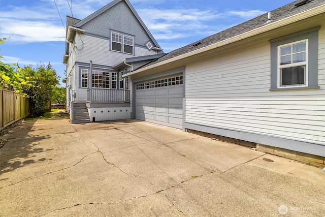 1615 Monroe St, Bellingham, WA 98225 - view of side of property with concrete driveway, a garage, and a shingled roof