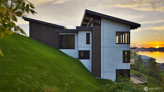 1017 California Ln SW, Seattle, WA 98116 - property exterior at dusk with a lawn
