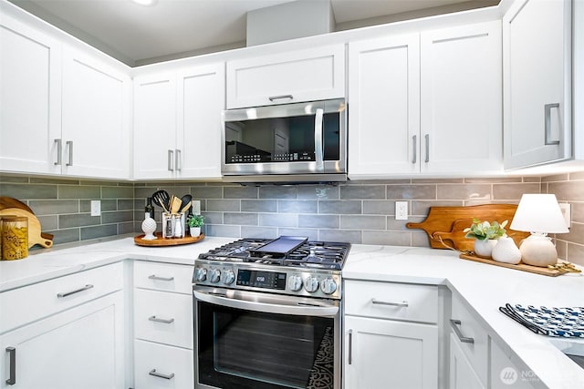 3906 141st Pl SE, Mill Creek, WA 98012 - kitchen featuring stainless steel appliances, white cabinetry, and backsplash