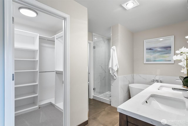 3906 141st Pl SE, Mill Creek, WA 98012 - full bathroom with a stall shower, a walk in closet, double vanity, tile patterned floors, and a freestanding tub