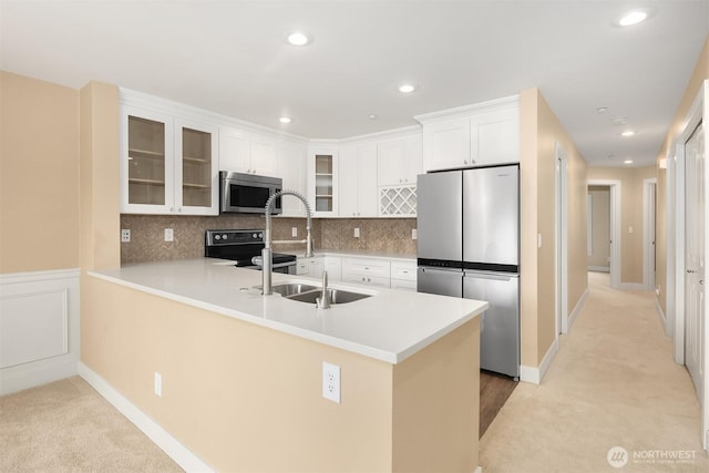 1957 23rd Pl NE Unit 201, Issaquah, WA 98029 - kitchen with appliances with stainless steel finishes, a peninsula, glass insert cabinets, light colored carpet, and recessed lighting