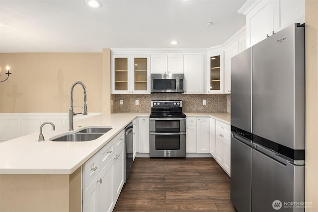1957 23rd Pl NE Unit 201, Issaquah, WA 98029 - kitchen with stainless steel appliances, a peninsula, light countertops, white cabinets, and recessed lighting