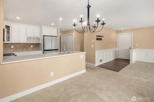 1957 23rd Pl NE Unit 201, Issaquah, WA 98029 - kitchen featuring stainless steel appliances, carpet, a chandelier, white cabinets, and light countertops