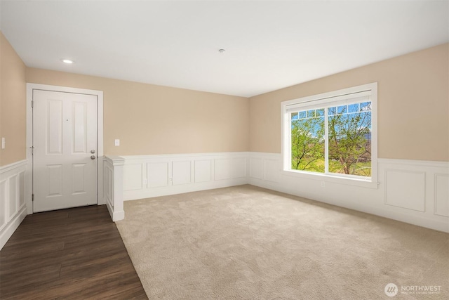1957 23rd Pl NE Unit 201, Issaquah, WA 98029 - empty room featuring wainscoting, a decorative wall, dark wood finished floors, and recessed lighting
