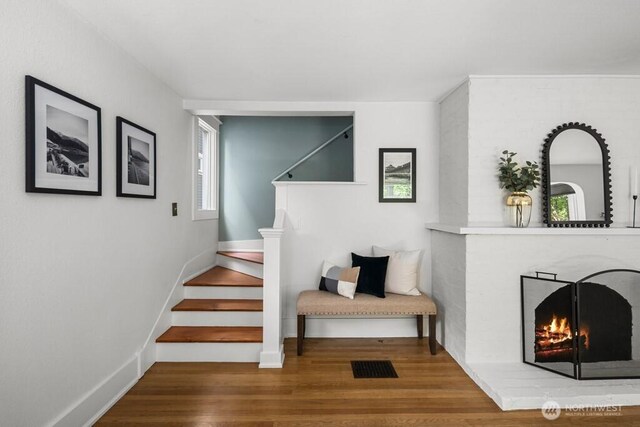 4055 SW Prince St, Seattle, WA 98116 - stairway with wood finished floors and a brick fireplace