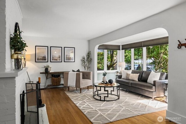 4055 SW Prince St, Seattle, WA 98116 - living area featuring arched walkways and wood finished floors