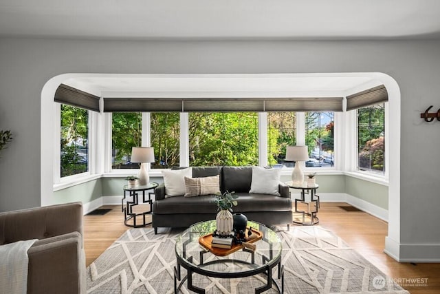 4055 SW Prince St, Seattle, WA 98116 - living room featuring wood finished floors and arched walkways