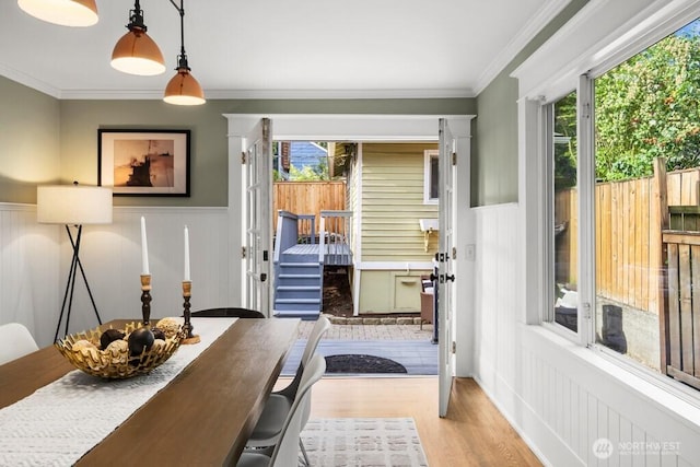 4055 SW Prince St, Seattle, WA 98116 - dining space featuring wood finished floors, wainscoting, crown molding, and a decorative wall