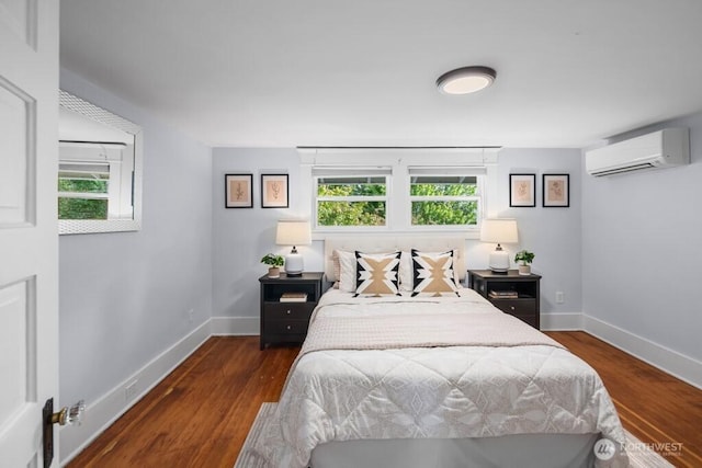 4055 SW Prince St, Seattle, WA 98116 - bedroom featuring a wall mounted air conditioner, multiple windows, and wood finished floors