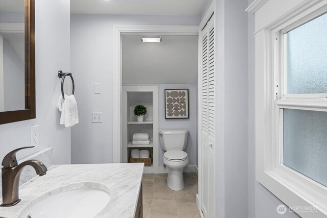 4055 SW Prince St, Seattle, WA 98116 - bathroom featuring a closet, vanity, tile patterned flooring, and built in shelves