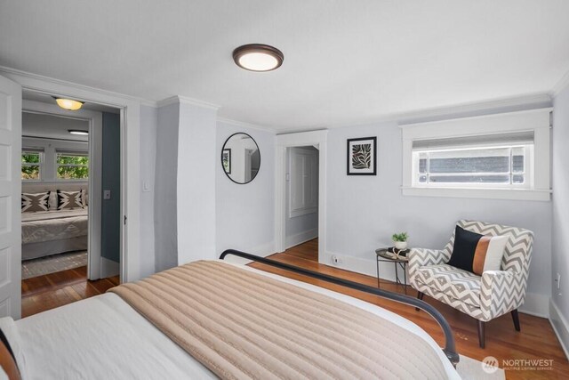 4055 SW Prince St, Seattle, WA 98116 - bedroom featuring wood finished floors and ornamental molding