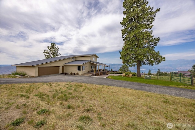 95 Horizon Ln, Chelan, WA 98816 - view of front of home with a garage, asphalt driveway, and a mountain view