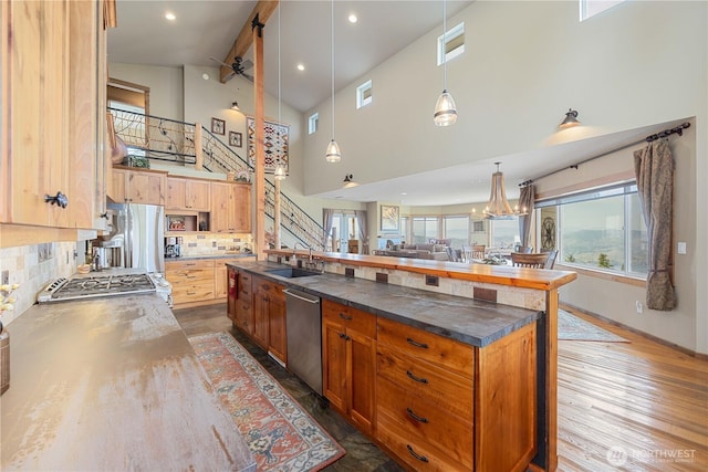95 Horizon Ln, Chelan, WA 98816 - kitchen featuring stainless steel appliances, a towering ceiling, tasteful backsplash, open floor plan, and dark countertops