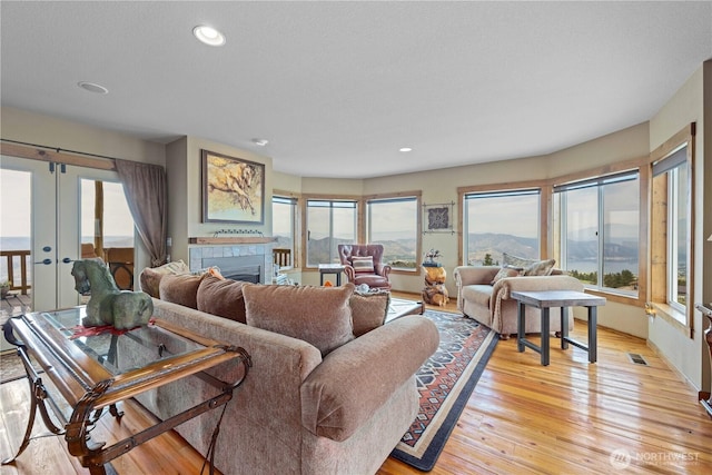 95 Horizon Ln, Chelan, WA 98816 - living room featuring light wood-style floors, a fireplace, recessed lighting, and french doors