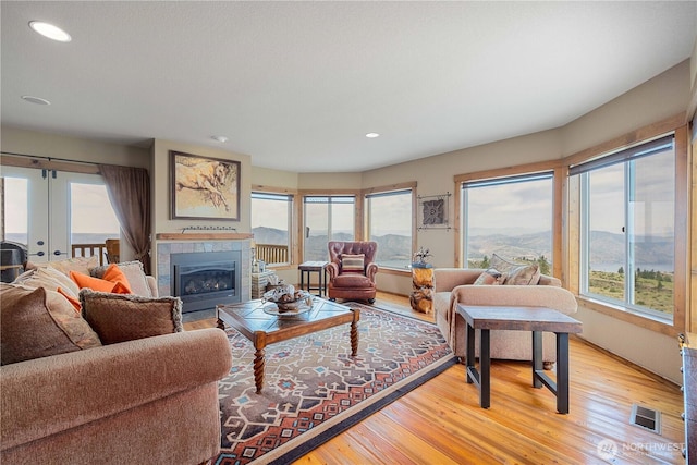 95 Horizon Ln, Chelan, WA 98816 - living area with light wood-type flooring, recessed lighting, a glass covered fireplace, and french doors