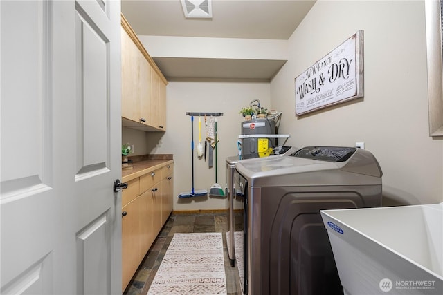 95 Horizon Ln, Chelan, WA 98816 - laundry area with washing machine and dryer, cabinet space, stone tile flooring, and strapped water heater