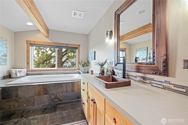 95 Horizon Ln, Chelan, WA 98816 - bathroom with stone tile floors, beam ceiling, a bath, vanity, and decorative backsplash