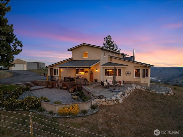 95 Horizon Ln, Chelan, WA 98816 - rear view of house featuring a patio, a garage, an outdoor living space, and a metal roof